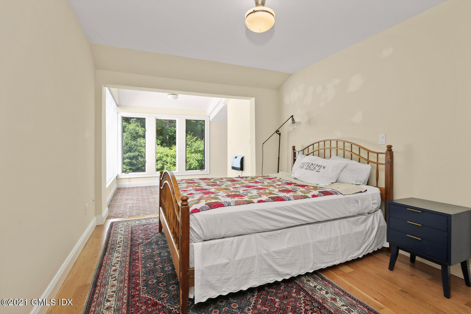 61 River Road Weston, CT 06883 - Photo 24 of 35 a bedroom with a bed and wooden floor