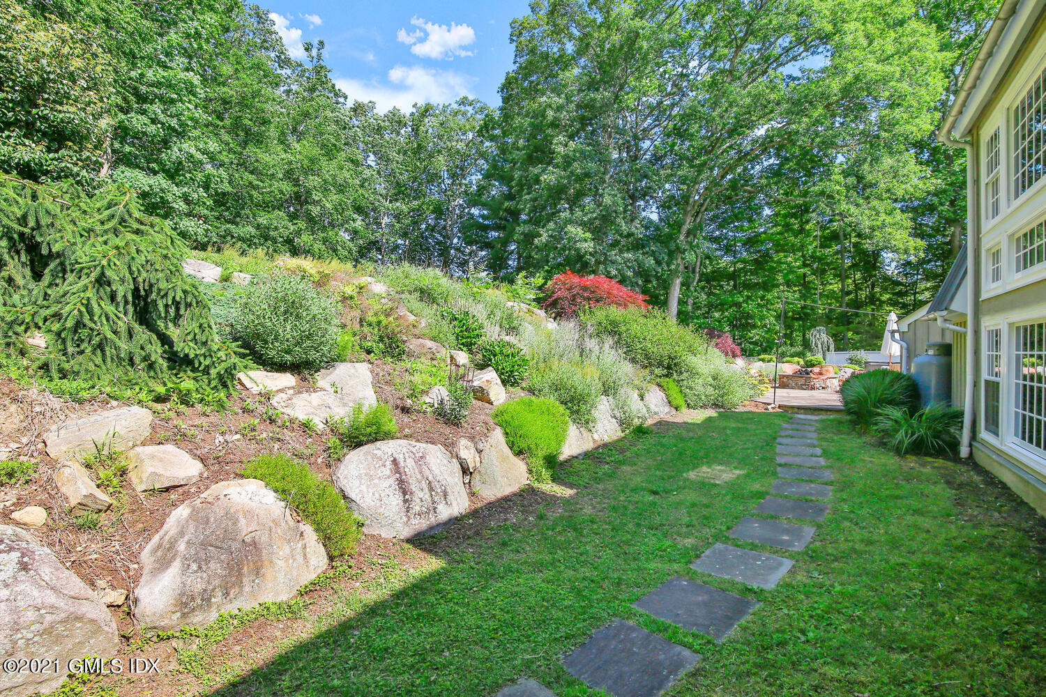 61 River Road Weston, CT 06883 - Photo 31 of 35 a backyard of a house with lots of green space and garden