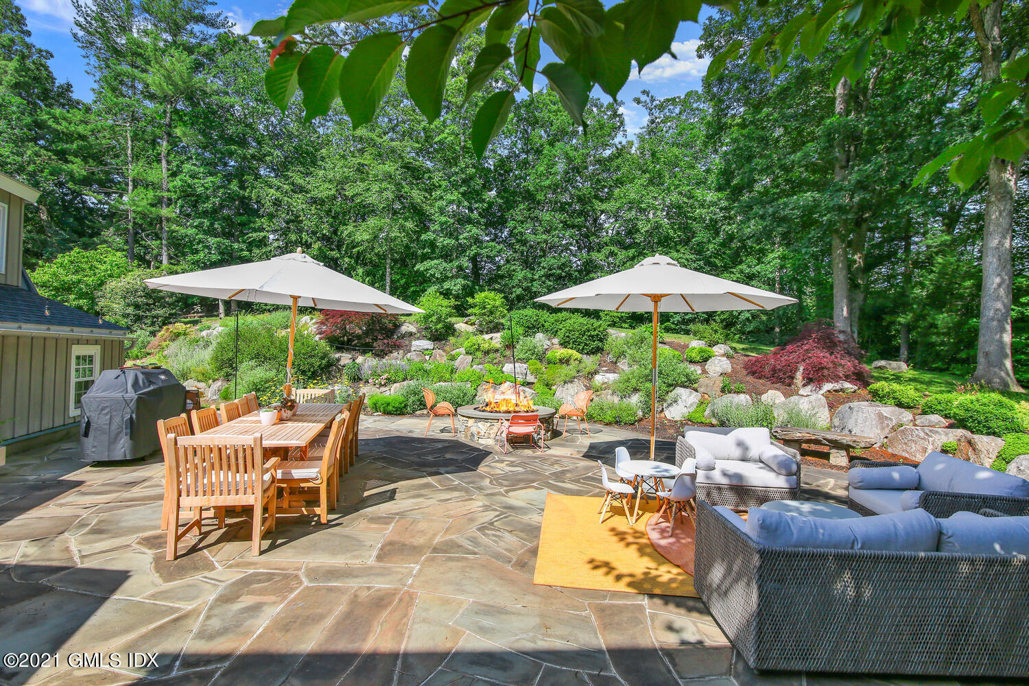 61 River Road Weston, CT 06883 - Photo 32 of 35 a chair and tables in the patio