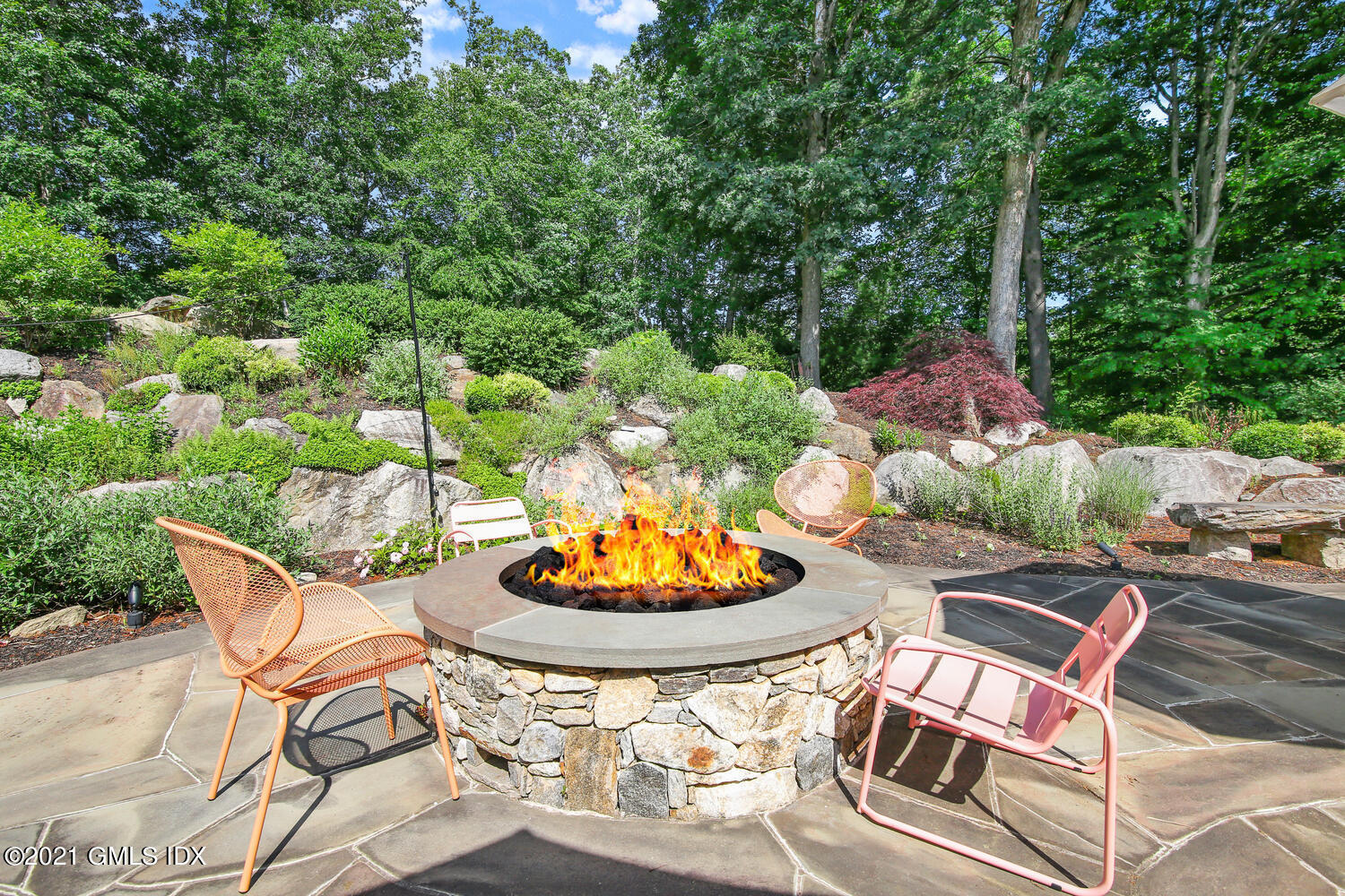61 River Road Weston, CT 06883 - Photo 33 of 35 a backyard of a house with a table and chairs