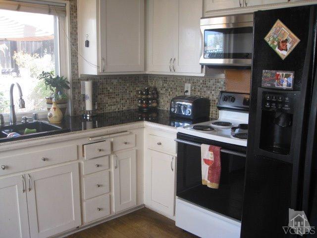 13343 Laurelhurst Road Moorpark, CA 93021 - Photo 12 of 36 a kitchen with stainless steel appliances granite countertop a refrigerator and a stove