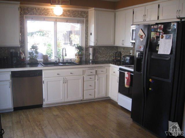 13343 Laurelhurst Road Moorpark, CA 93021 - Photo 13 of 36 a kitchen with granite countertop a refrigerator sink and cabinets