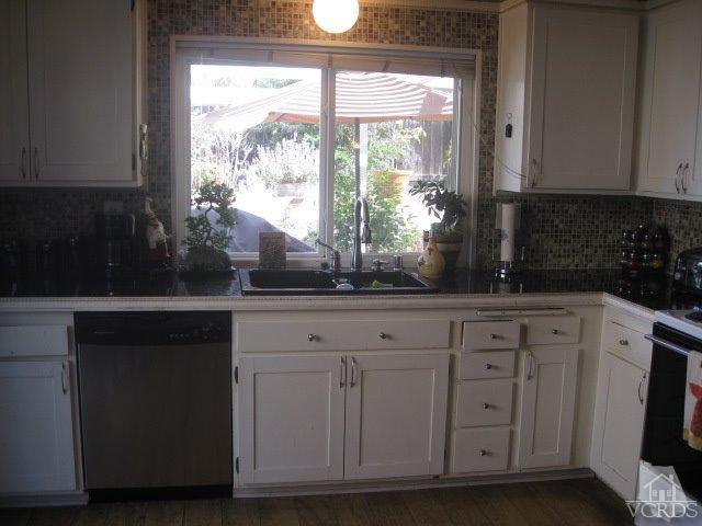 13343 Laurelhurst Road Moorpark, CA 93021 - Photo 14 of 36 a kitchen with white cabinets and a window