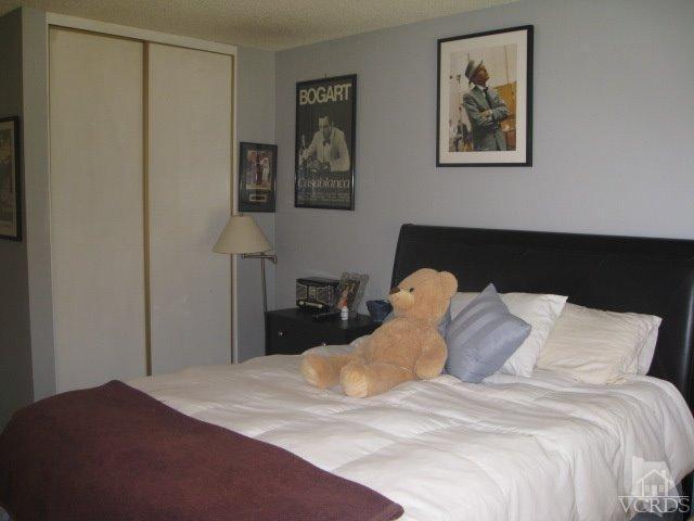 13343 Laurelhurst Road Moorpark, CA 93021 - Photo 21 of 36 a bedroom with a bed and painting on the wall
