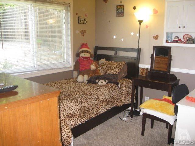 13343 Laurelhurst Road Moorpark, CA 93021 - Photo 28 of 36 a bedroom with a bed and wooden floor