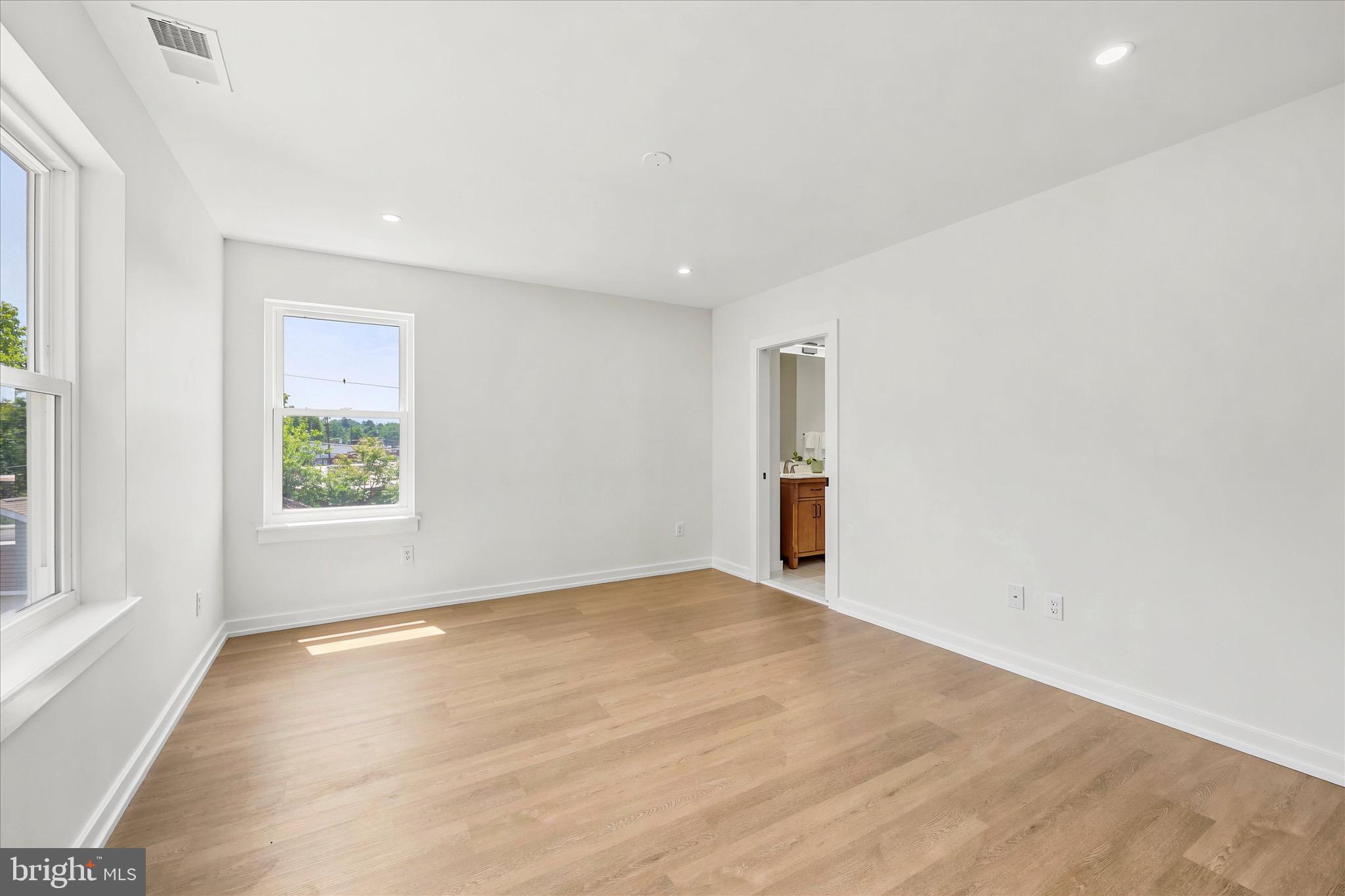 8 James Road Broomall, PA 19008 - Photo 21 of 35 a view of an empty room with wooden floor and a window