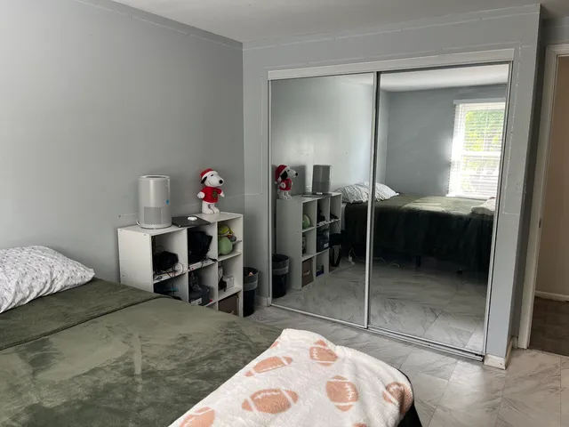 a bedroom with a bed and a dresser