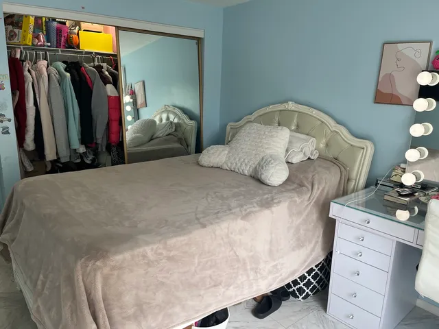 a bedroom with a bed and a closet