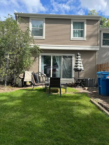 a view of a house with backyard porch and sitting area