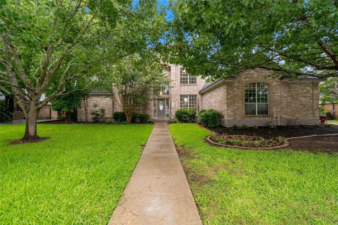 11720 Hobbiton Trail Austin, TX 78739 - Photo 1 of 1 a view of a white house in front of a big yard with large trees
