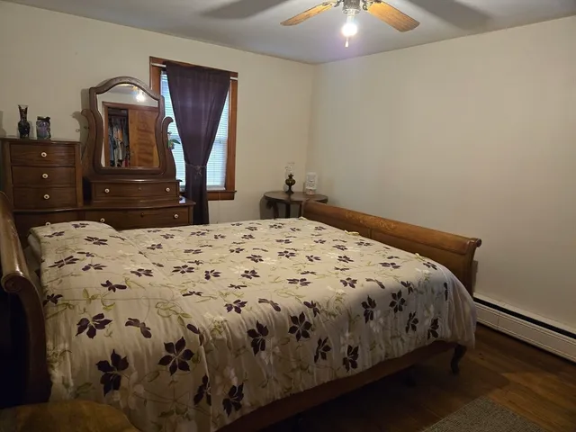 a bedroom with a bed and a dresser