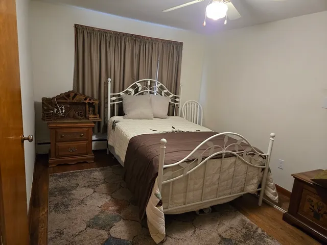 a bedroom with a bed and a tv