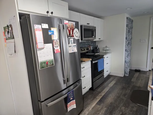 a kitchen with stainless steel appliances a refrigerator sink and microwave