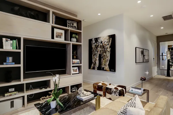 a room with furniture a flat screen tv and a window