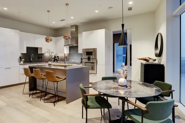 a kitchen with stainless steel appliances a stove refrigerator and microwave