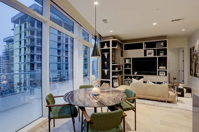 a bedroom with furniture and a flat screen tv