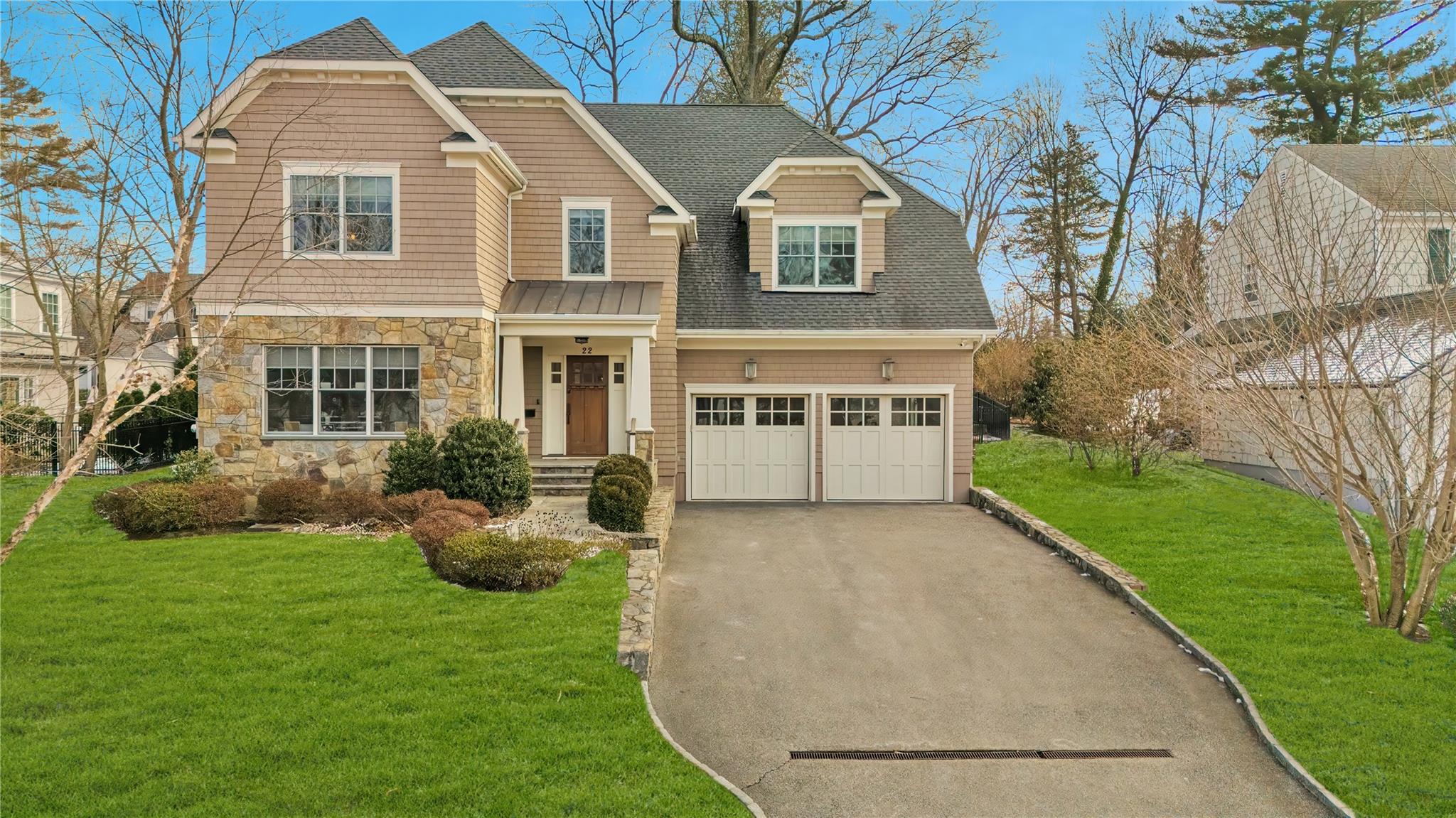 View of front facade featuring a 2 car garage and a front yard