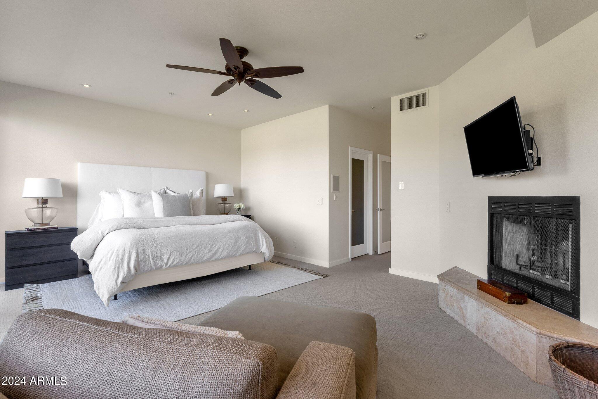 7700 East Gainey Ranch Road, Unit 146 Scottsdale, AZ 85258 - Photo 17 of 36 Fireplace In Master Bedroom