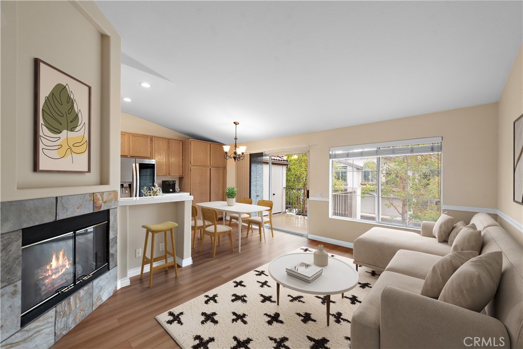 a living room with furniture a large window and a fireplace