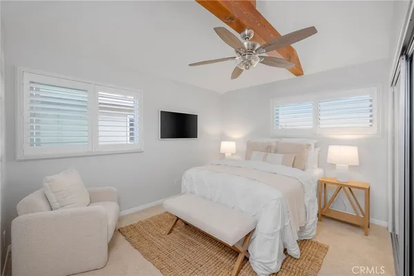 a bedroom with furniture and a flat screen tv