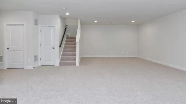 a view of an empty room with stairs