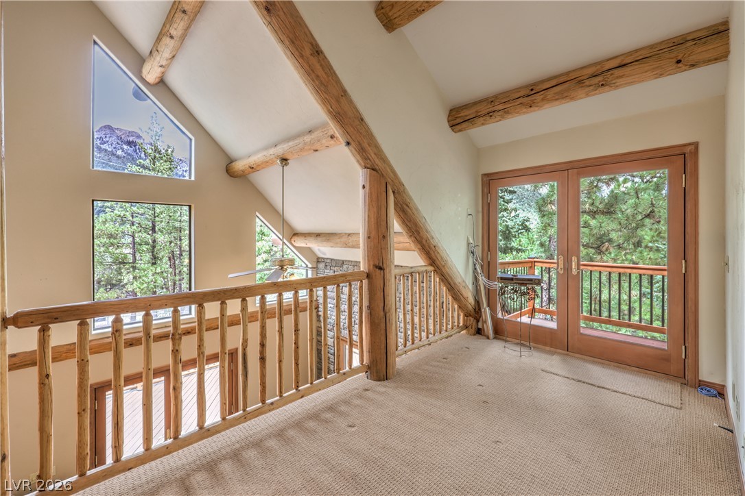 322 Ski Trail Road Mount Charleston, NV 89124 - Photo 25 of 58 Exposed log beams frame a cozy loft area leading to a private balcony.
