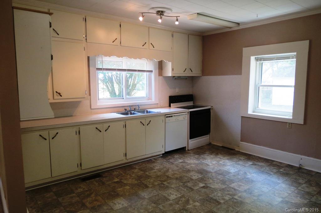 207 Rogers Lake Road Kannapolis, NC 28081 - Photo 12 of 21 a kitchen with granite countertop white cabinets stainless steel appliances a sink and a window