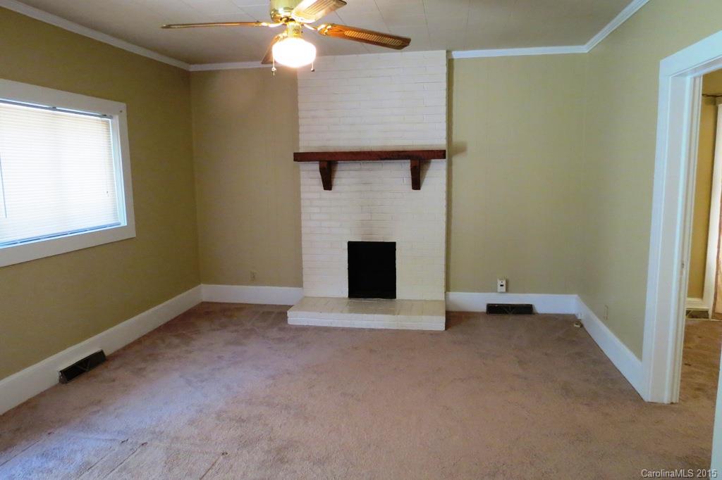 207 Rogers Lake Road Kannapolis, NC 28081 - Photo 6 of 21 an empty room with windows and fireplace