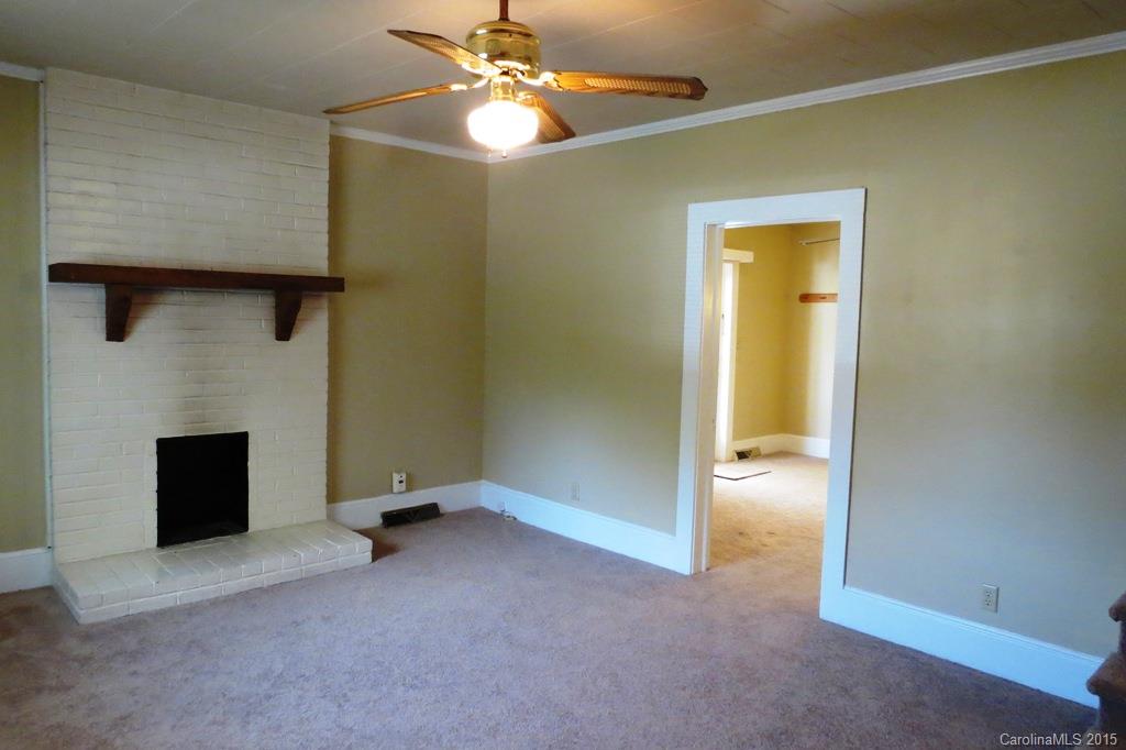 207 Rogers Lake Road Kannapolis, NC 28081 - Photo 7 of 21 an empty room with a ceiling fan and a window