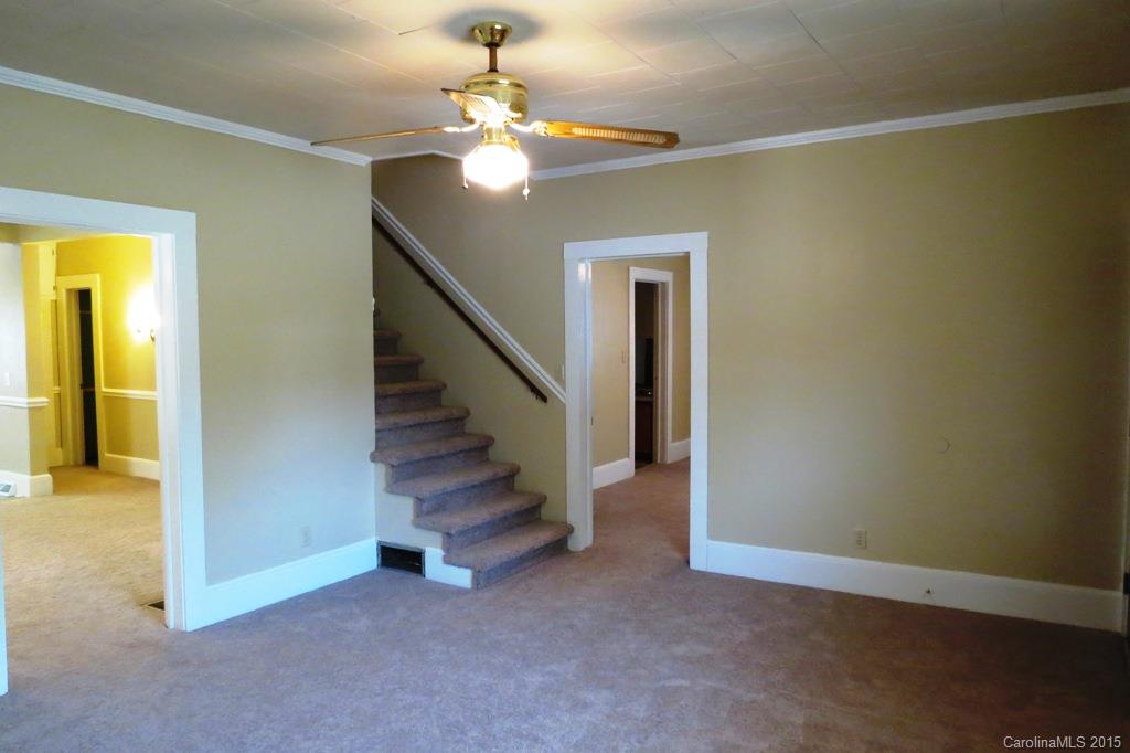 207 Rogers Lake Road Kannapolis, NC 28081 - Photo 8 of 21 an empty room with a chandelier fan and a bathroom