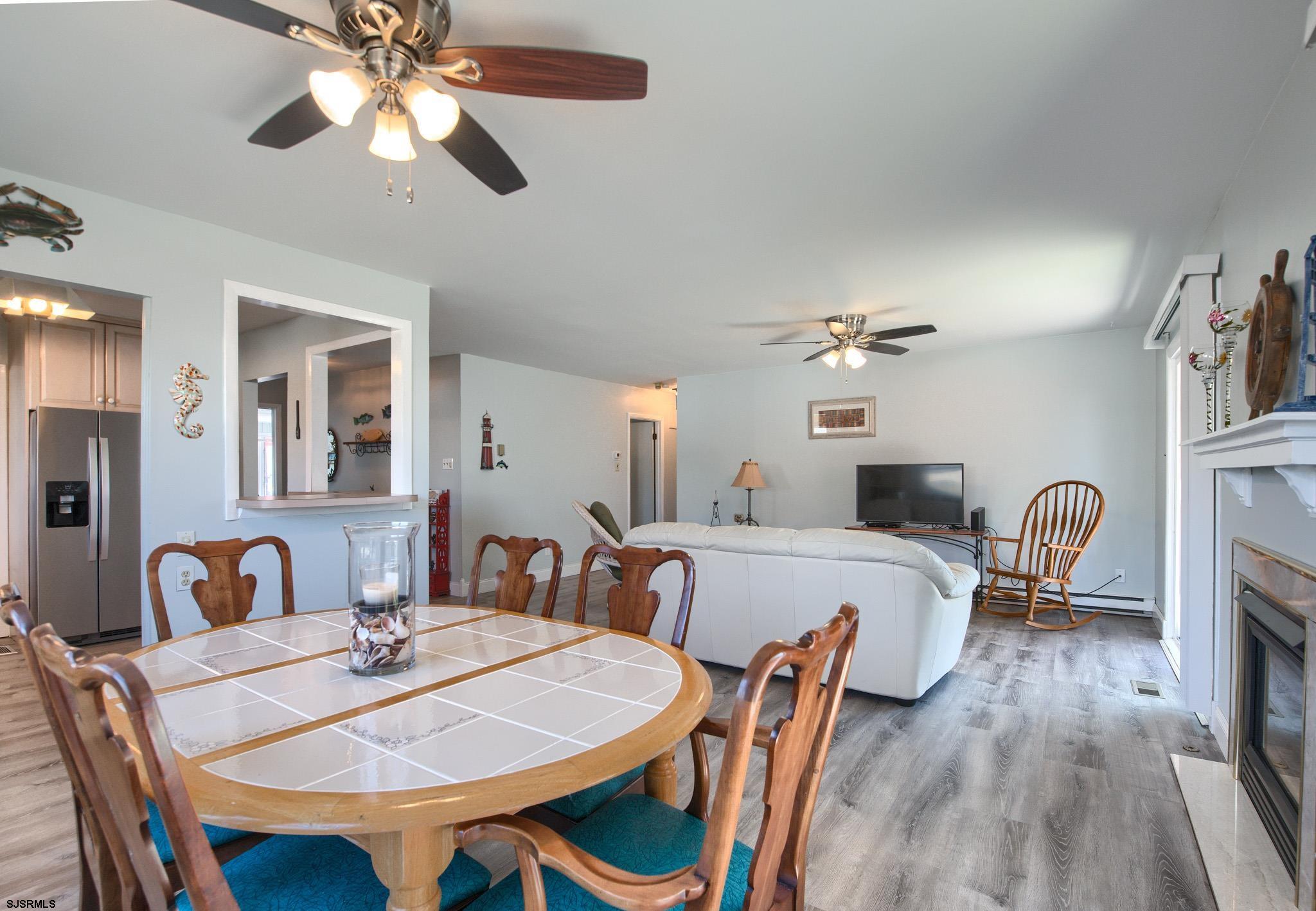 2 Surf Lane Brigantine, NJ 08203 - Photo 13 of 42 a view of a dining room with furniture a chandelier and wooden floor