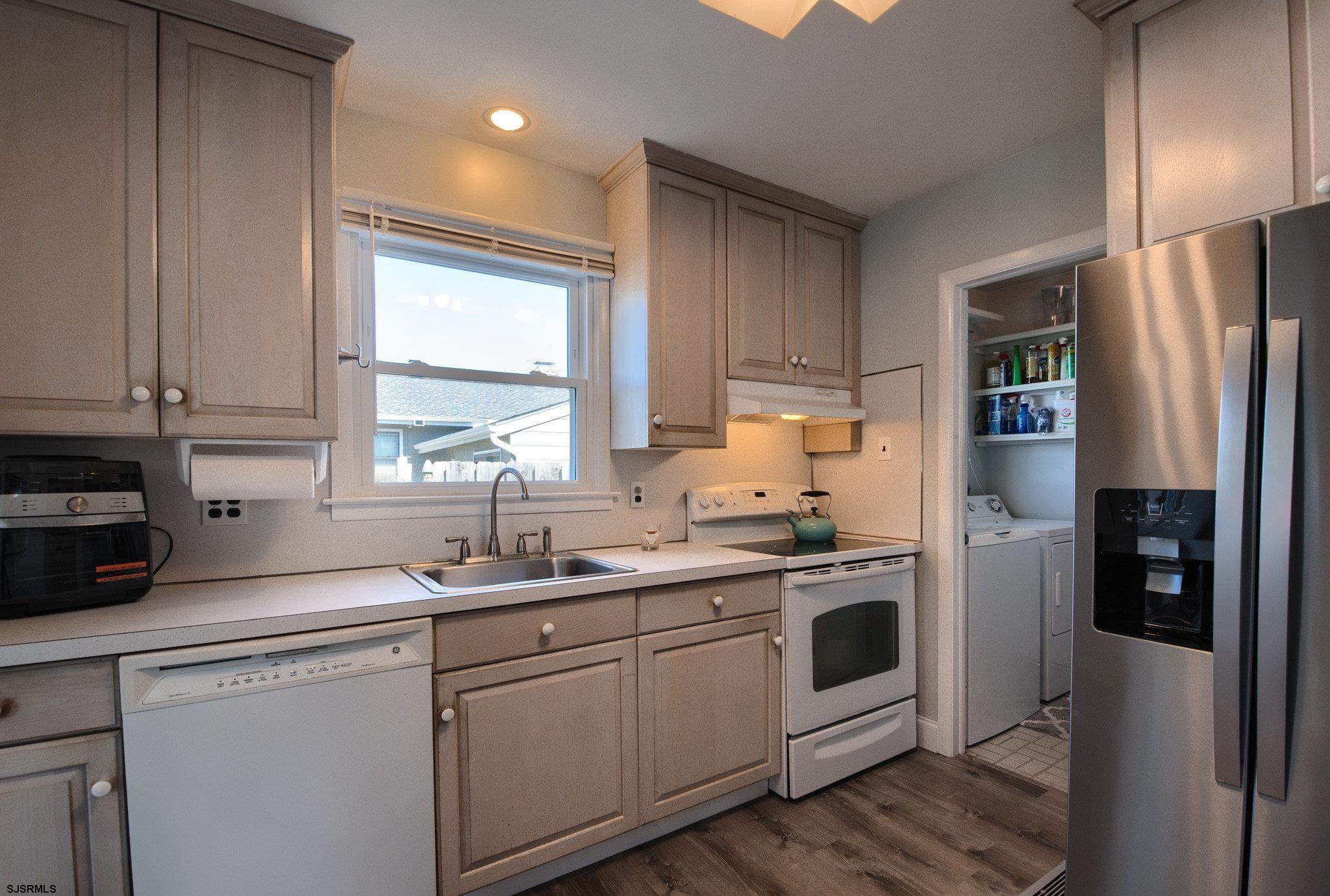 2 Surf Lane Brigantine, NJ 08203 - Photo 15 of 42 a kitchen with stainless steel appliances a sink cabinets and a window