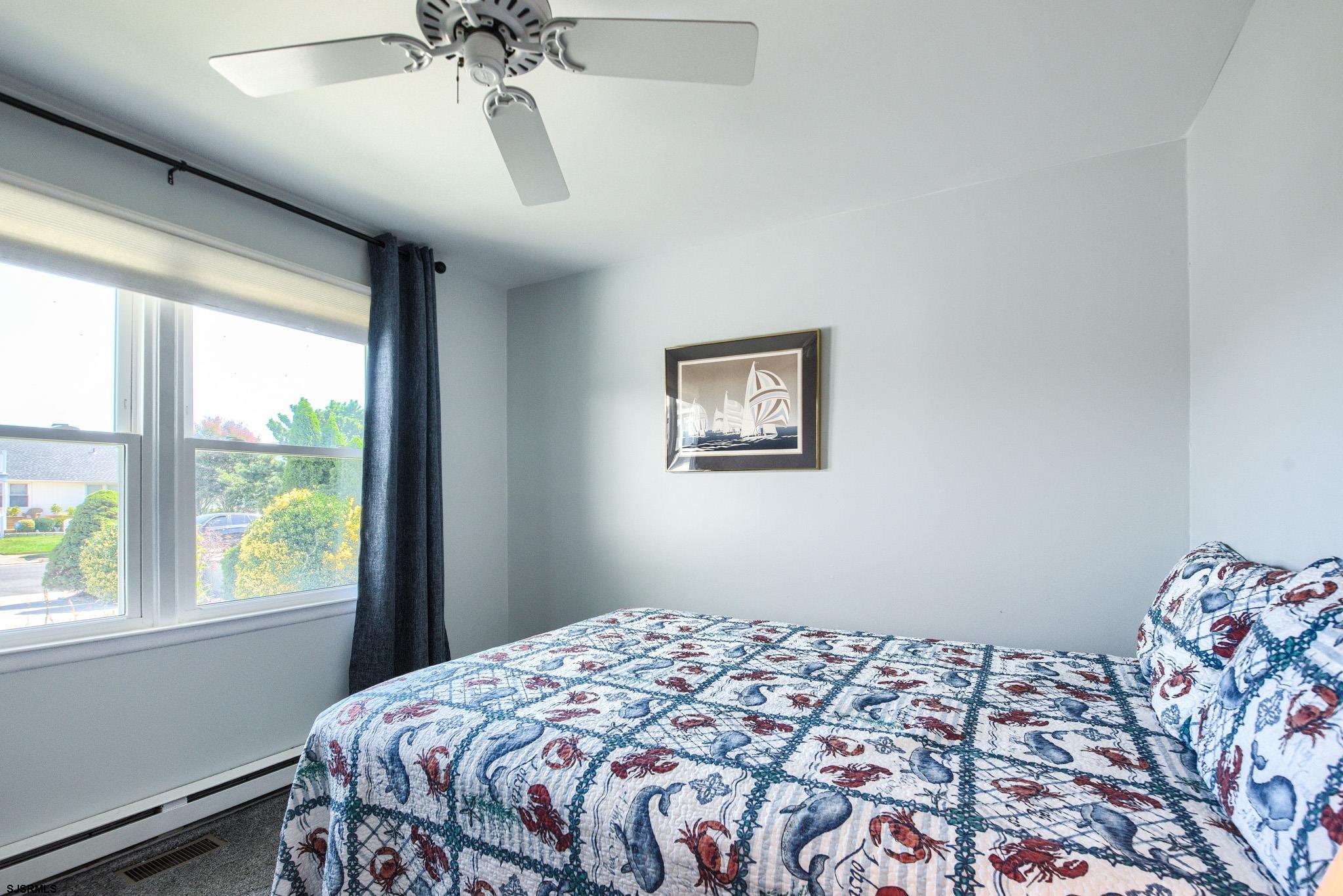 2 Surf Lane Brigantine, NJ 08203 - Photo 22 of 42 a bedroom with a bed and a window