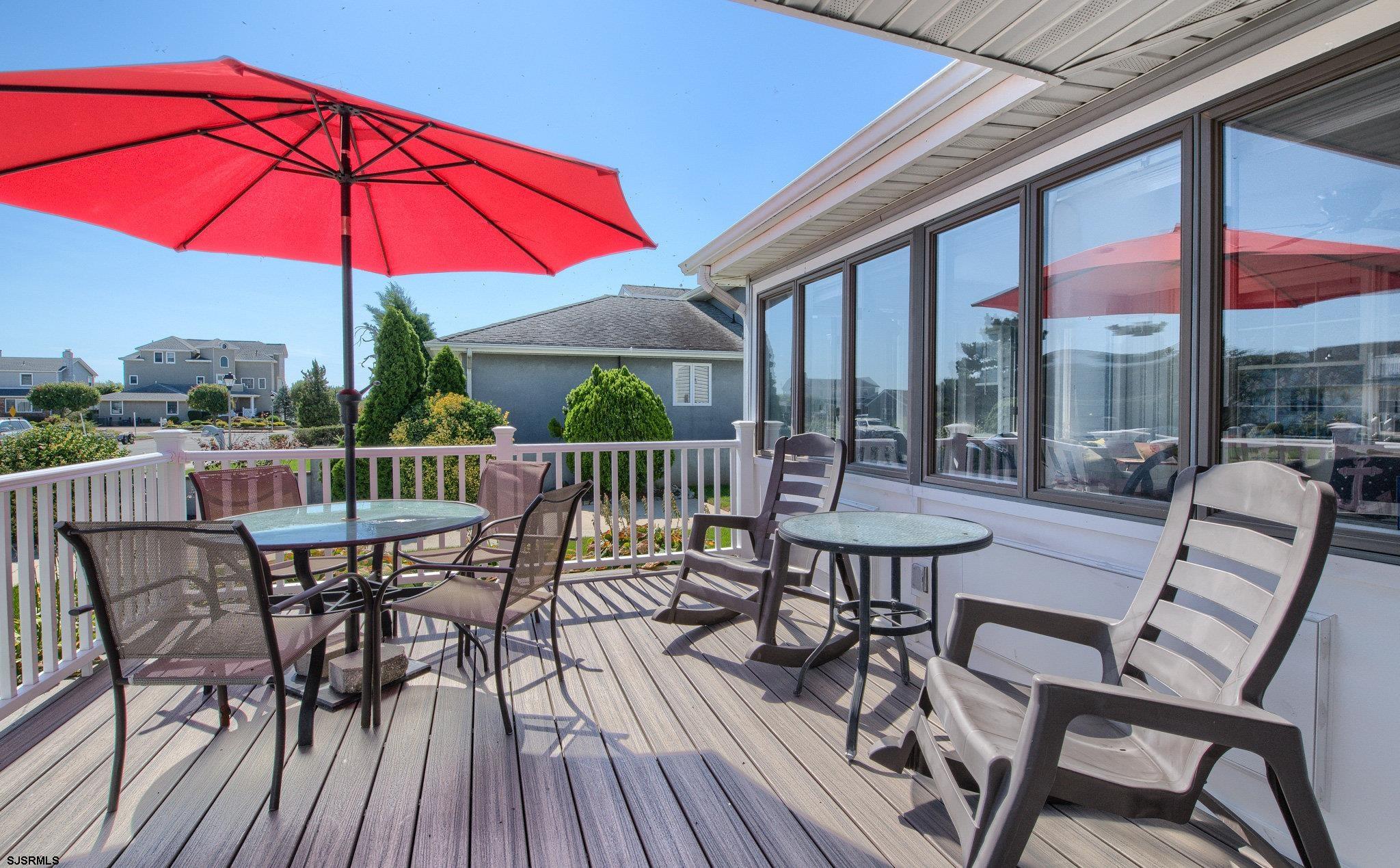 2 Surf Lane Brigantine, NJ 08203 - Photo 4 of 42 a view of a patio with a table and chairs