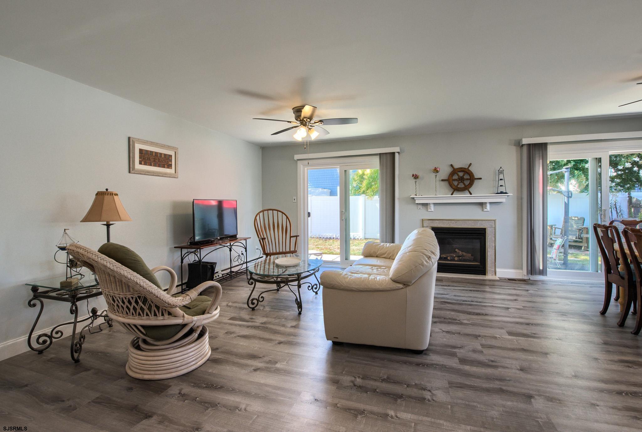 2 Surf Lane Brigantine, NJ 08203 - Photo 8 of 42 a living room with furniture and a fireplace