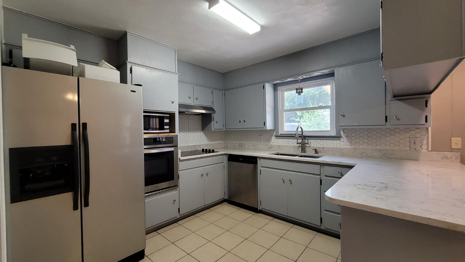 5430 13th Street Lubbock, TX 79416 - Photo 18 of 26 a kitchen with stainless steel appliances a refrigerator sink and stove
