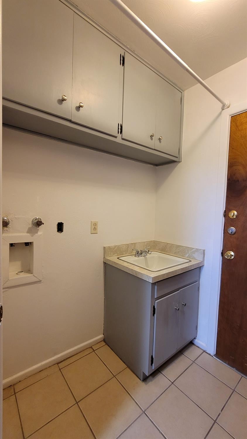 5430 13th Street Lubbock, TX 79416 - Photo 22 of 26 a kitchen with granite countertop cabinets and white appliances