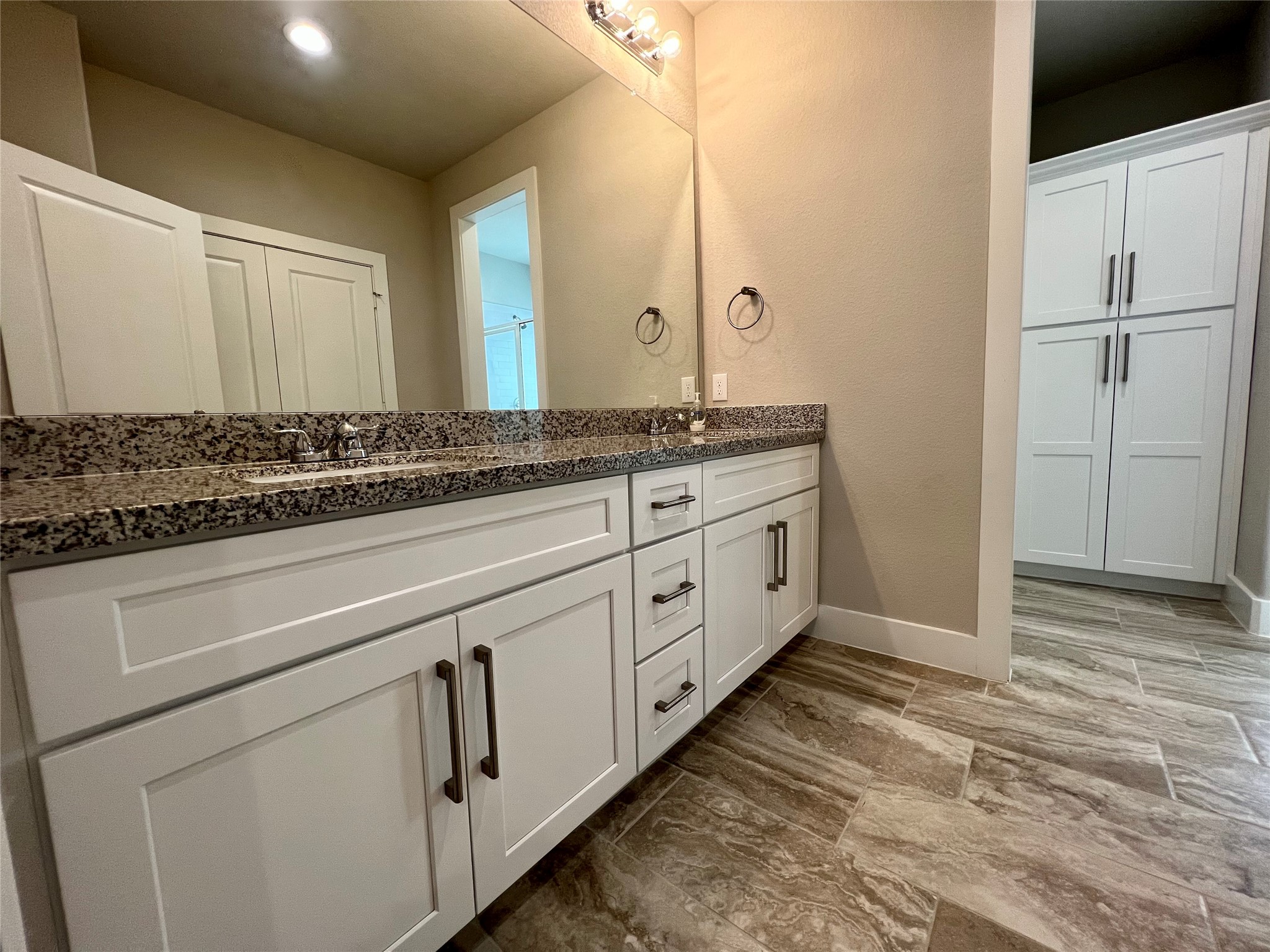 4301 Clover Street Houston, TX 77051 - Photo 21 of 31 Guest bathroom with double vanity and extra cabinetry for storage.