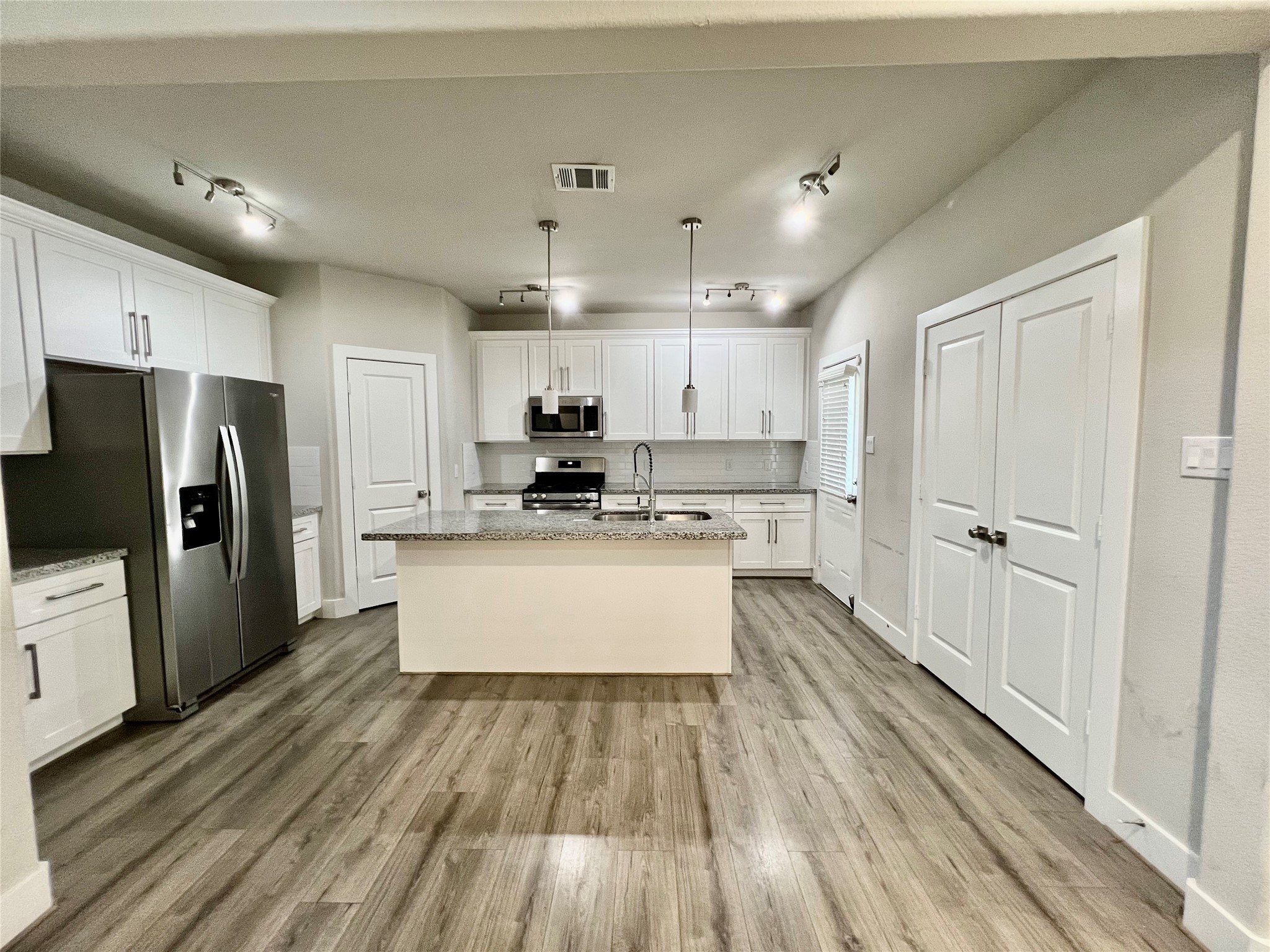 4301 Clover Street Houston, TX 77051 - Photo 5 of 32 a kitchen with stainless steel appliances a refrigerator sink and cabinets