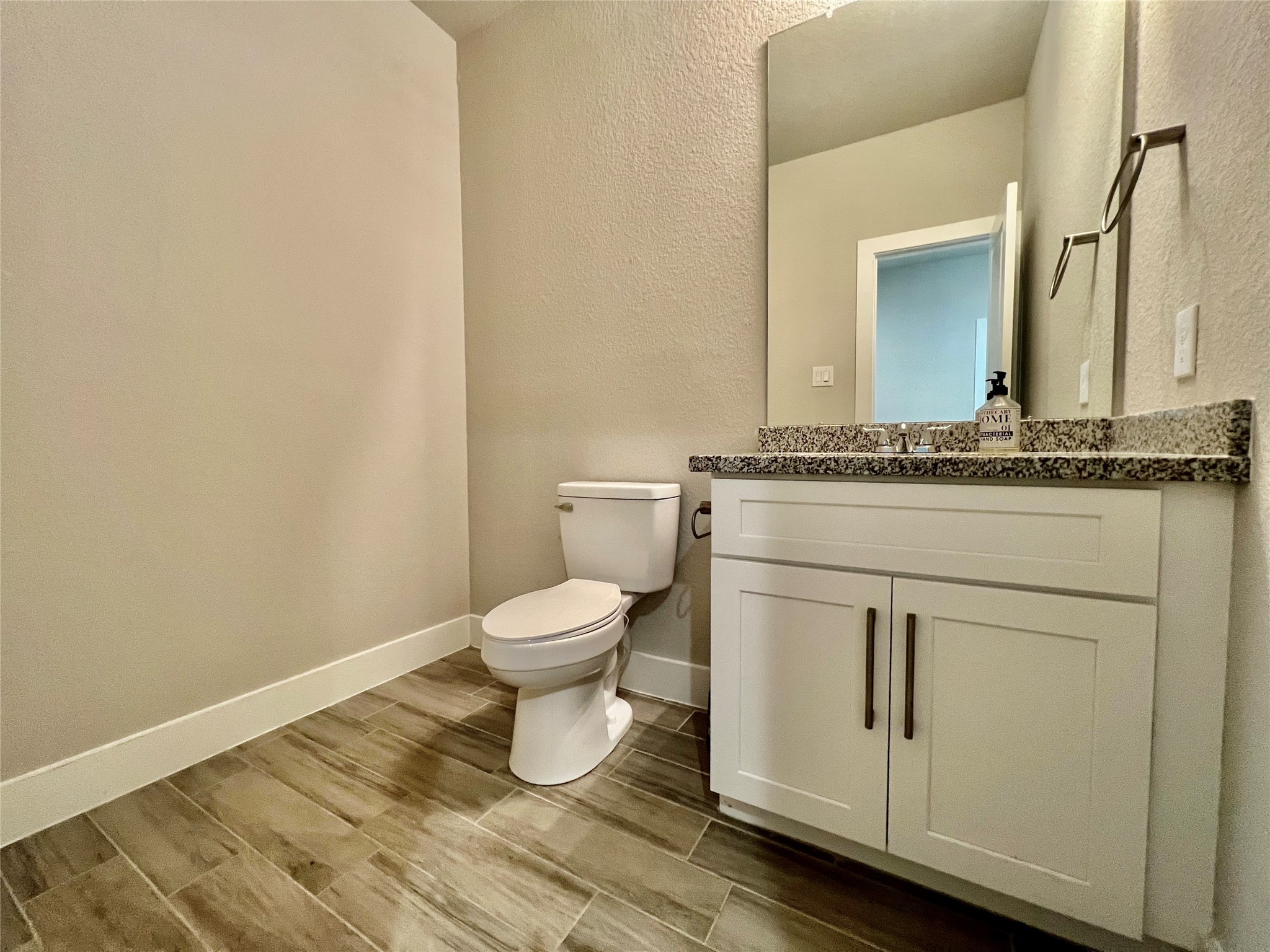 4301 Clover Street Houston, TX 77051 - Photo 9 of 32 a bathroom with a granite countertop toilet and a sink