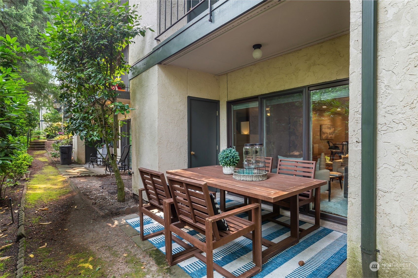 8520 242nd Street Southwest, Unit 101 Edmonds, WA 98026 - Photo 32 of 36 a view of a patio with table and chairs and potted plants