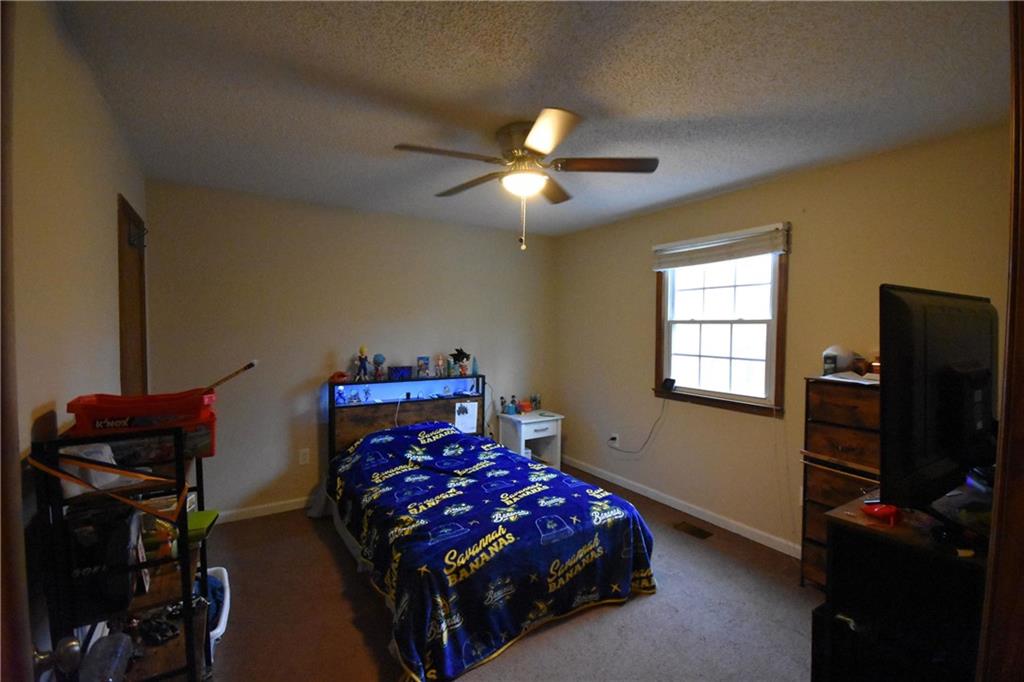 1968 Allgood Church Road Temple, GA 30179 - Photo 20 of 43 a bedroom with a bed and a flat tv screen on dresser