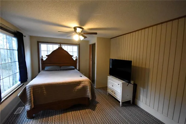 a bedroom with a bed and a television
