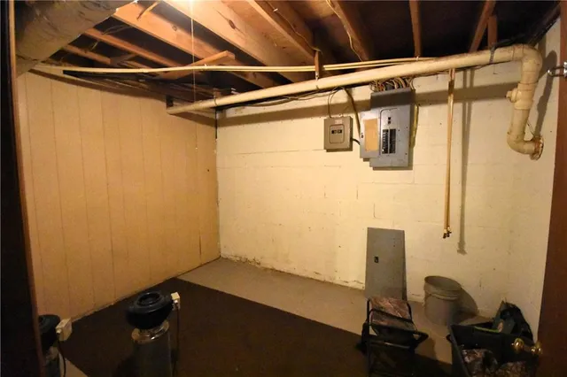 a view of backyard with large trees and wooden fence