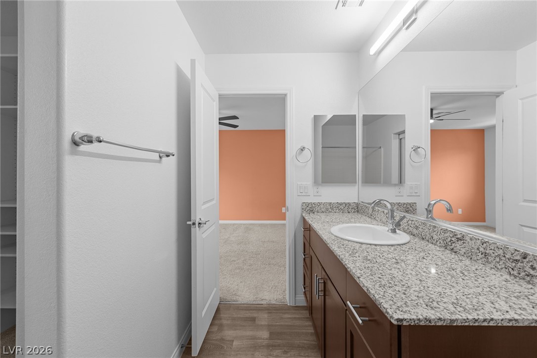 12367 Indigo Montage Road, Unit 3 Las Vegas, NV 89183 - Photo 15 of 33 This bathroom features a sleek vanity with ample counter space and a clean, inviting aesthetic.