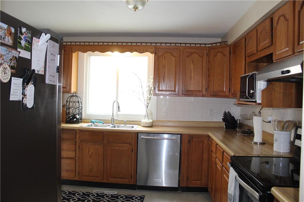 244 Rider Church Road Butler, PA 16001 - Photo 3 of 17 a kitchen with stainless steel appliances a sink a stove and a cabinets