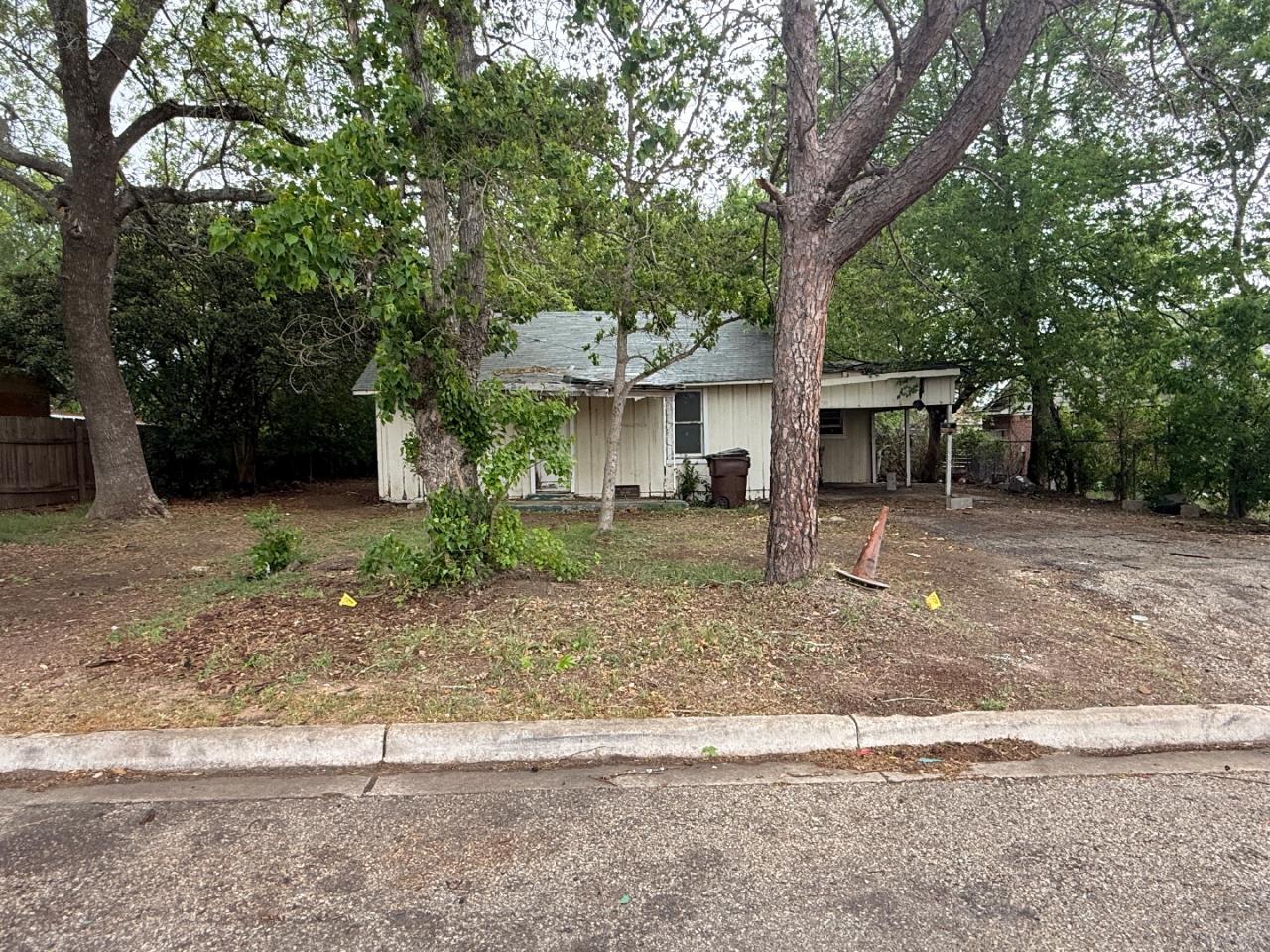 918 Brazos Street Lockhart, TX 78644 - Photo 1 of 14 a front view of a house with a yard garage and outdoor seating