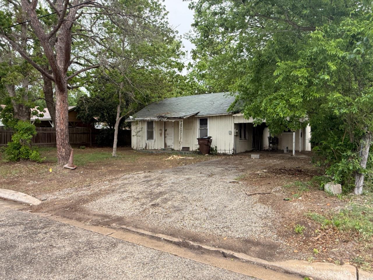 918 Brazos Street Lockhart, TX 78644 - Photo 2 of 14 a view of a house with a yard and large tree