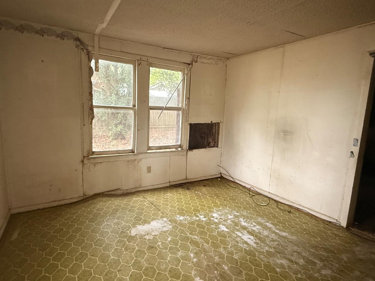 918 Brazos Street Lockhart, TX 78644 - Photo 3 of 14 a view of an empty room with a window