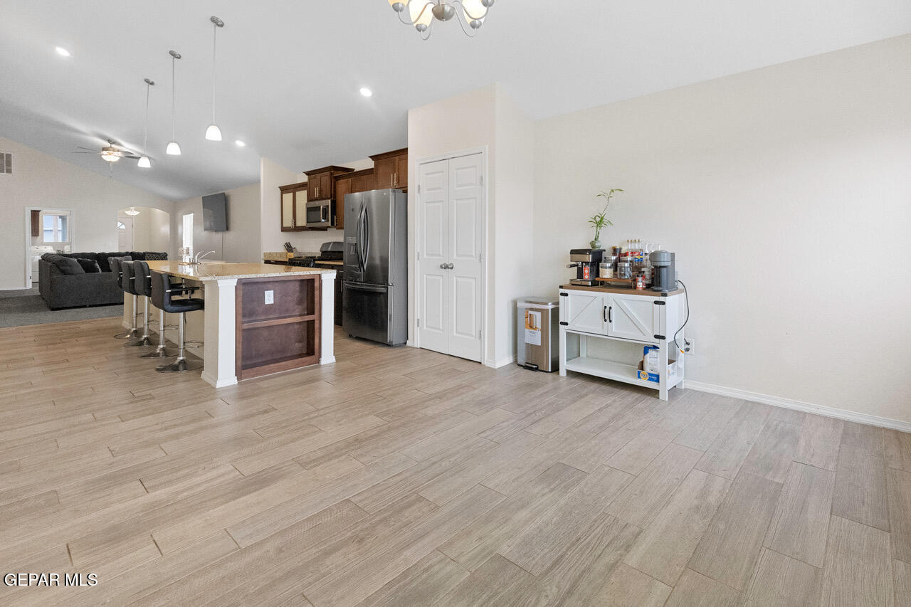 11288 Santa Barbara Socorro, TX 79927 - Photo 12 of 31 a view of a kitchen with stainless steel appliances wooden floor and living room view